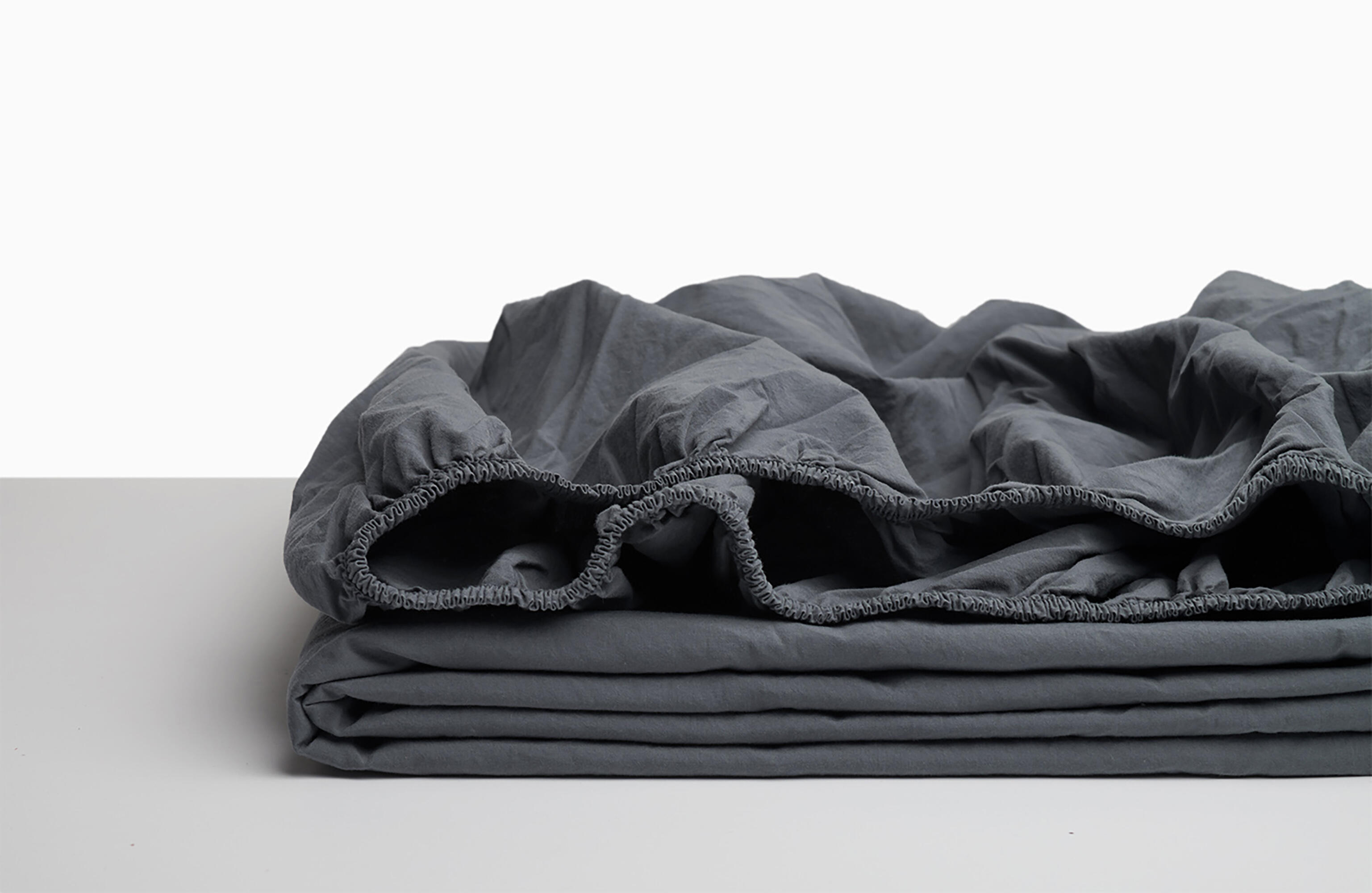 Sábana bajera wash garment percal 200 hilos gris para cama de 135 cm