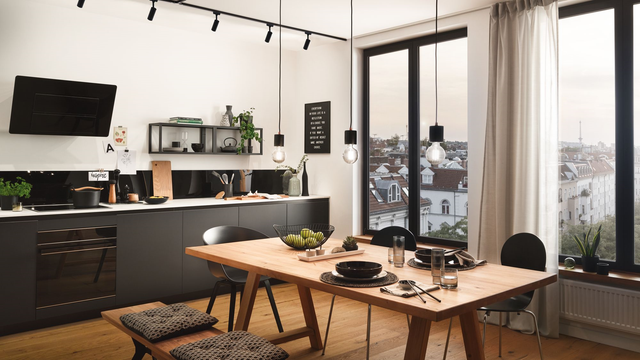 Cocina de casa moderna en blanco y negro con suelo de madera. 