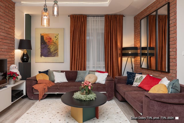 Kolorowy salon, fioletowa kanapa, miedziane zasłony