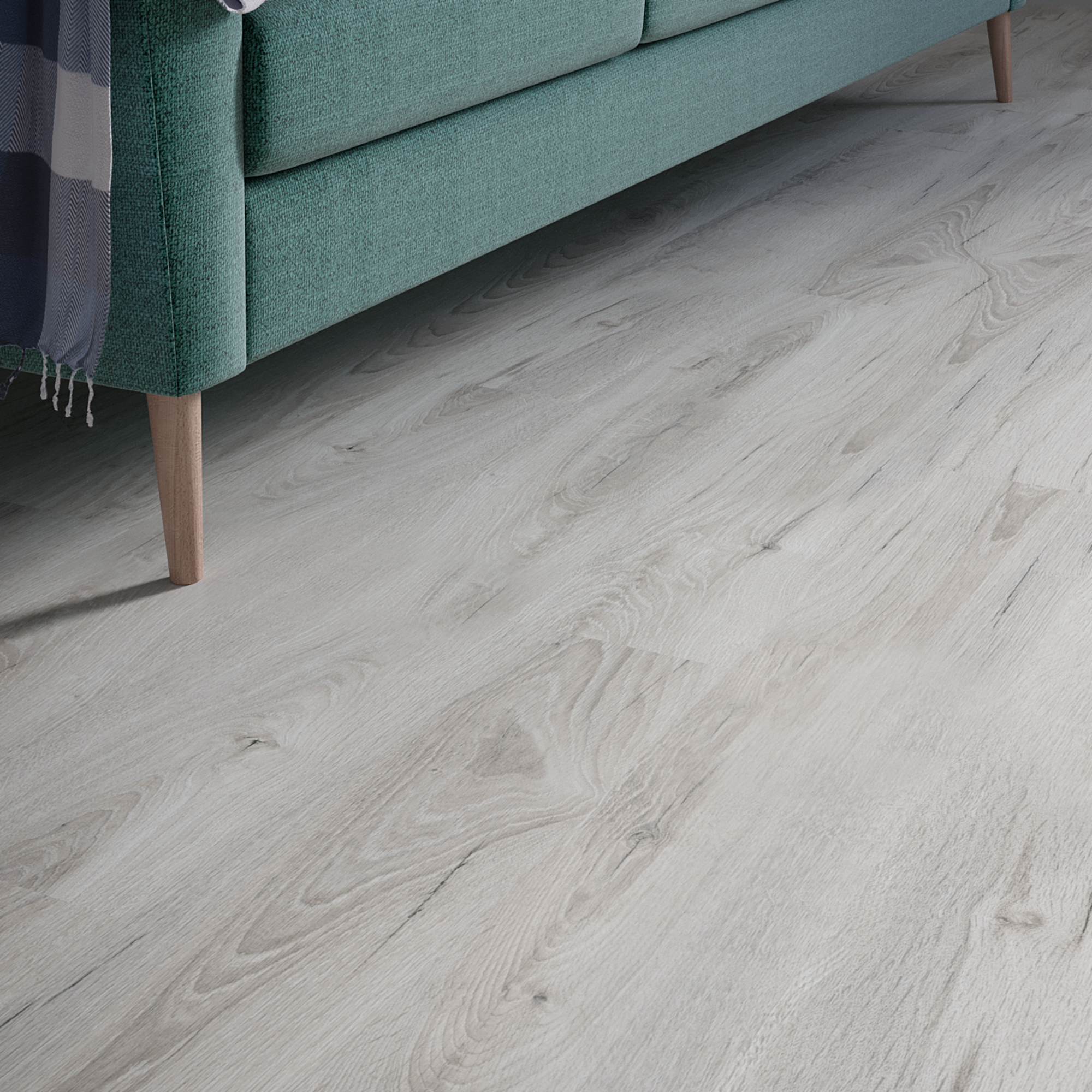 Podłoga z paneli laminowanych Promo Flooring Dąb Jasper obok sofy.