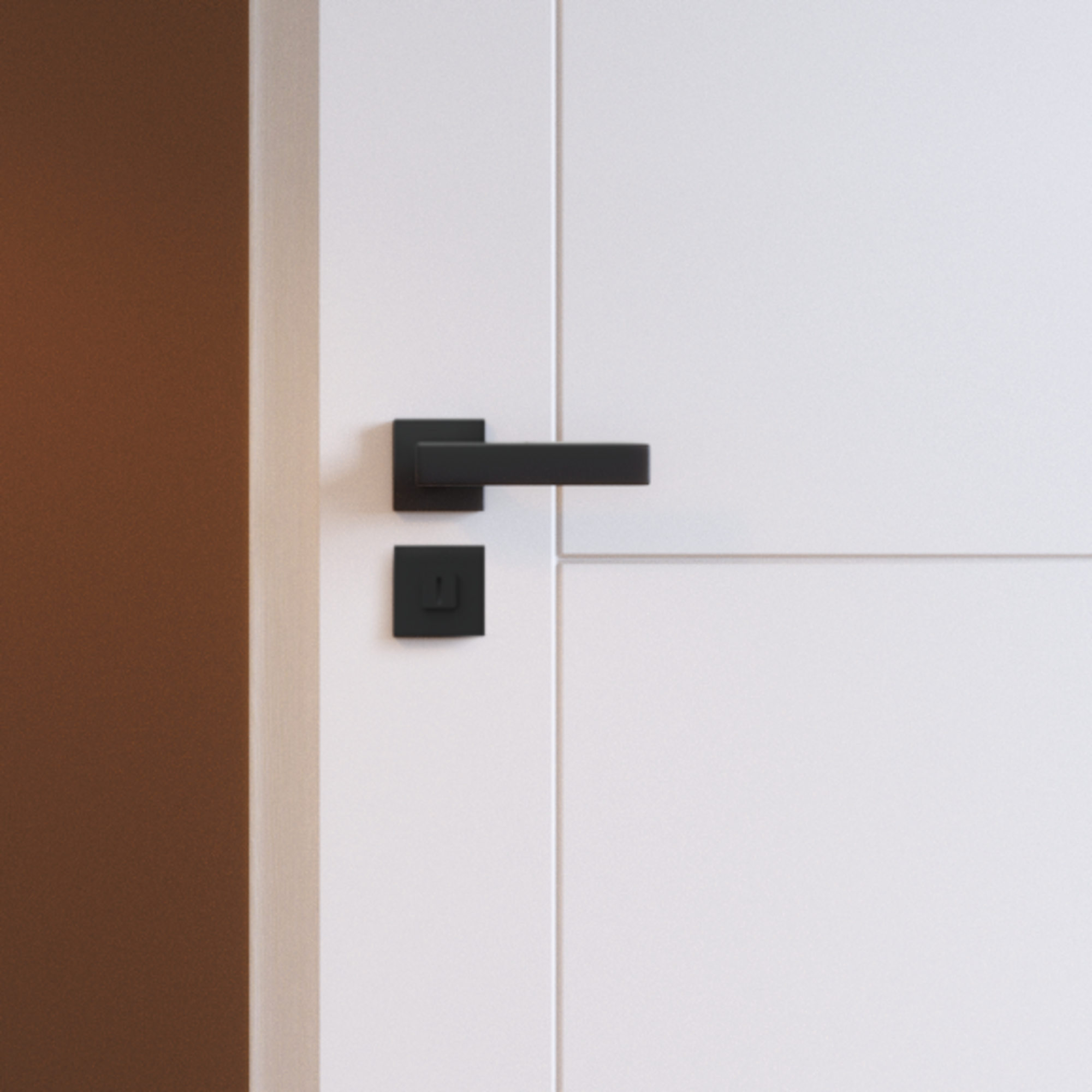 Czarna klamka i zamek w białych drzwiach.