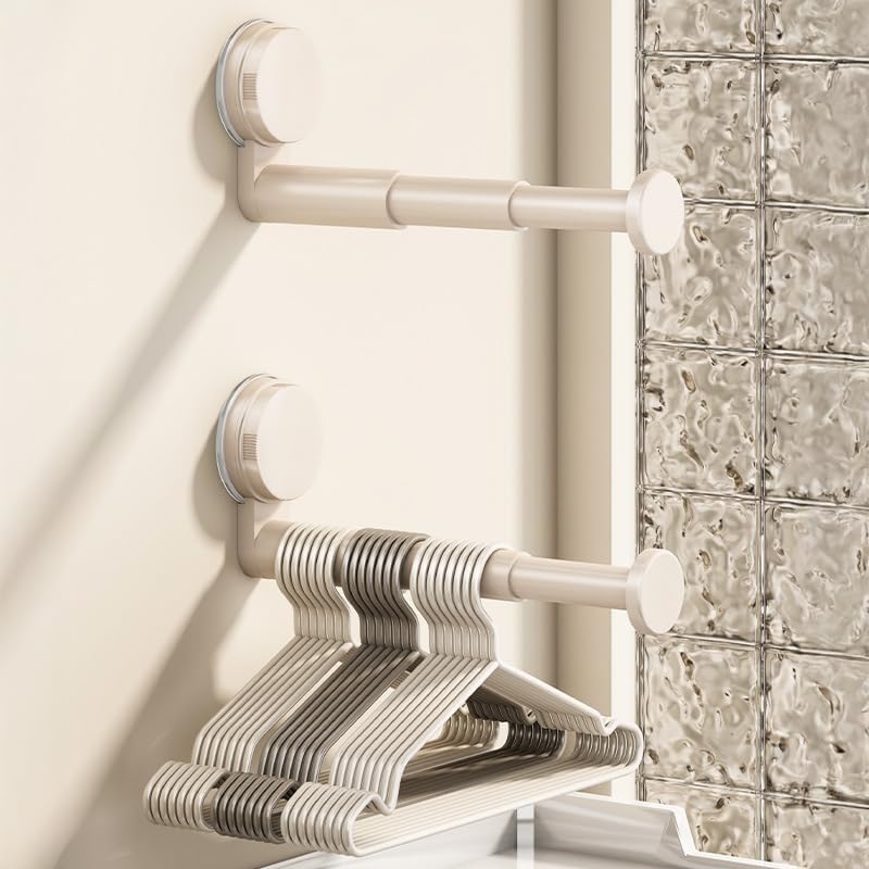 Dwie oszczędzające miejsce, chowane, montowane na ścianie suszarki do ubrań, odpowiednie do łazienek, balkonów i pralni. Beżowe.