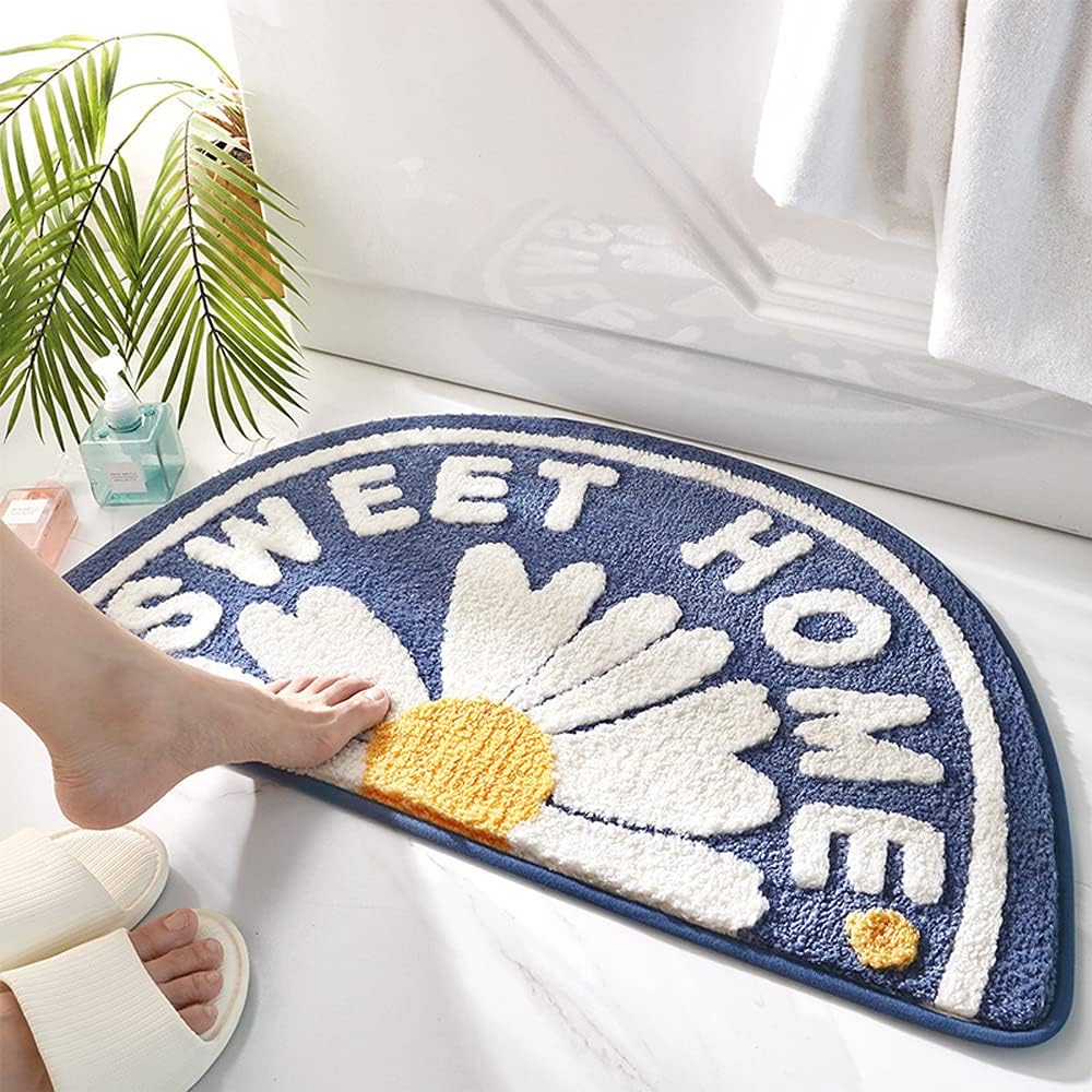 Niebieska antypoślizgowa mata łazienkowa, 75 x 45 cm, zmywalna, z nadrukiem stokrotek.