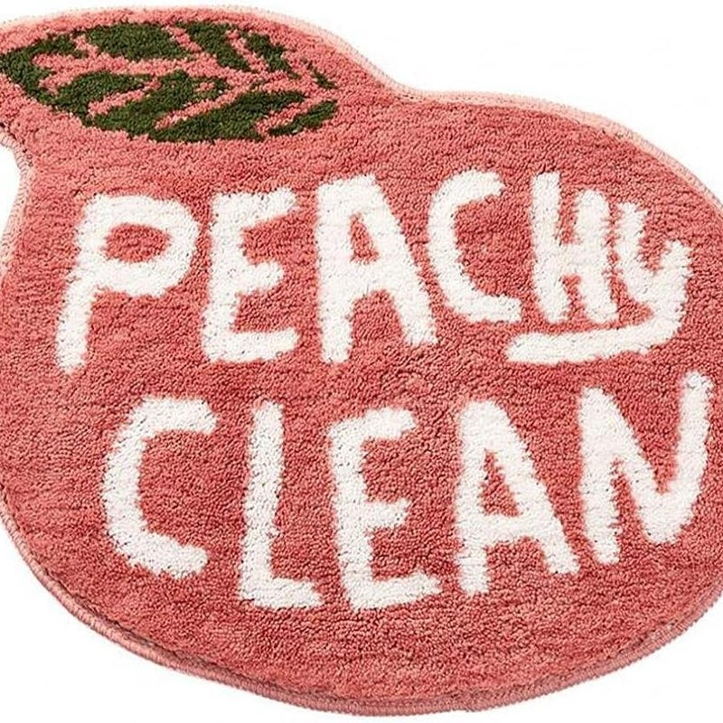 Mata łazienkowa antypoślizgowa o wymiarach 55 x 63 cm, w kolorze koralowo-różowo-brzoskwiniowym, z pluszowym materiałem pochłaniającym wodę.