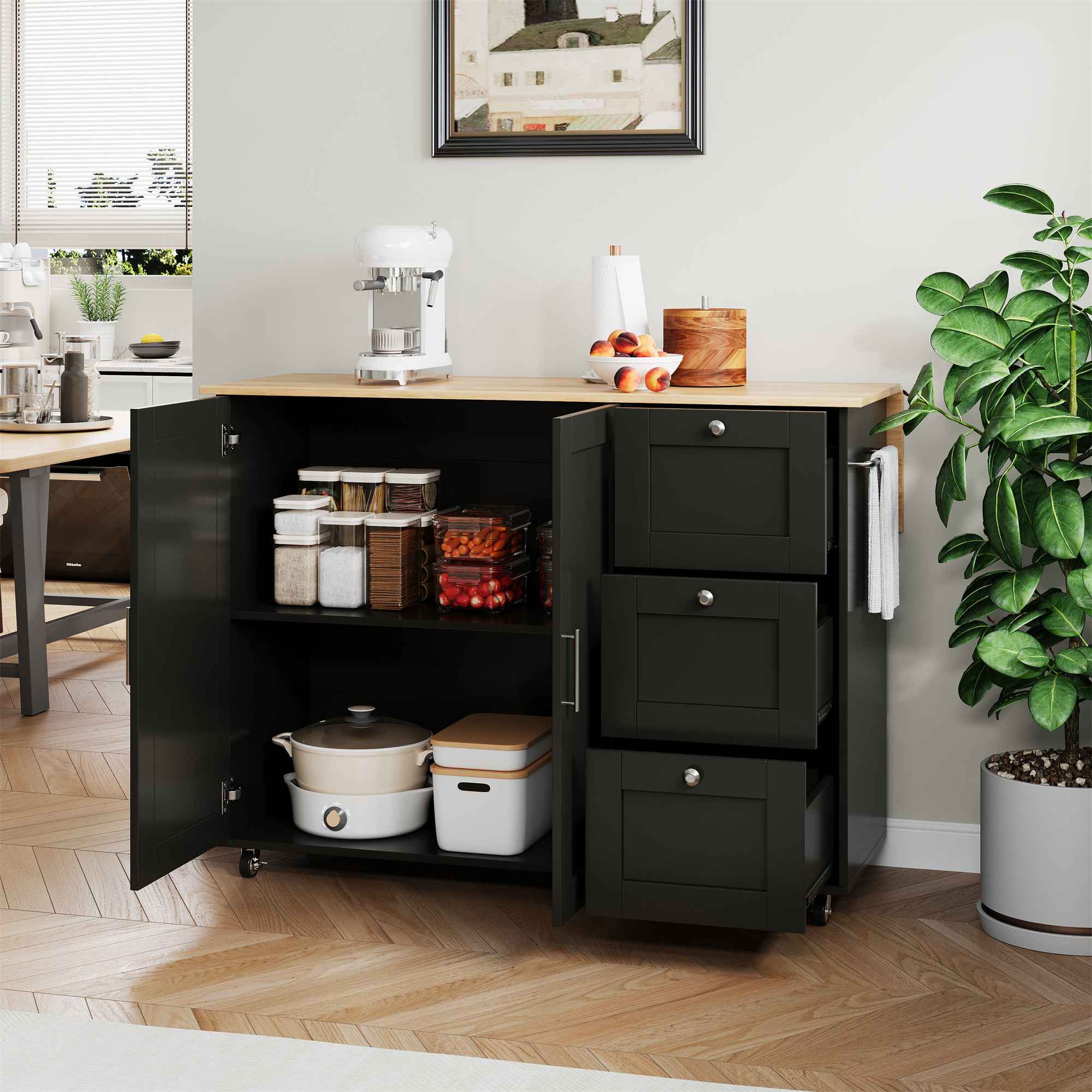 Mobilna wyspa kuchenna 135x44/70x90 cm z składanym blatem dębowym, 3 szufladami i hamulcami na kółkach, czarna